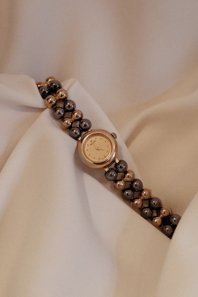 Vintage Seiko Ladies Petite Mixed Gold and Gunmetal Watch with Gold Dial