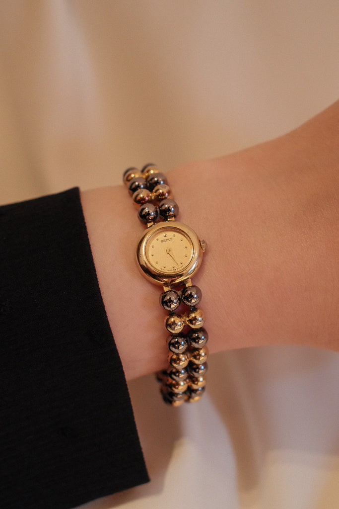 Vintage Seiko Ladies Petite Mixed Gold and Gunmetal Watch with Gold Dial